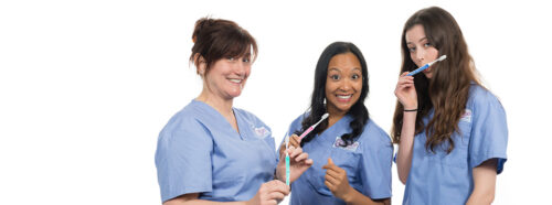 3 women in blue scrubs holding toothbrushes in Sydney studio