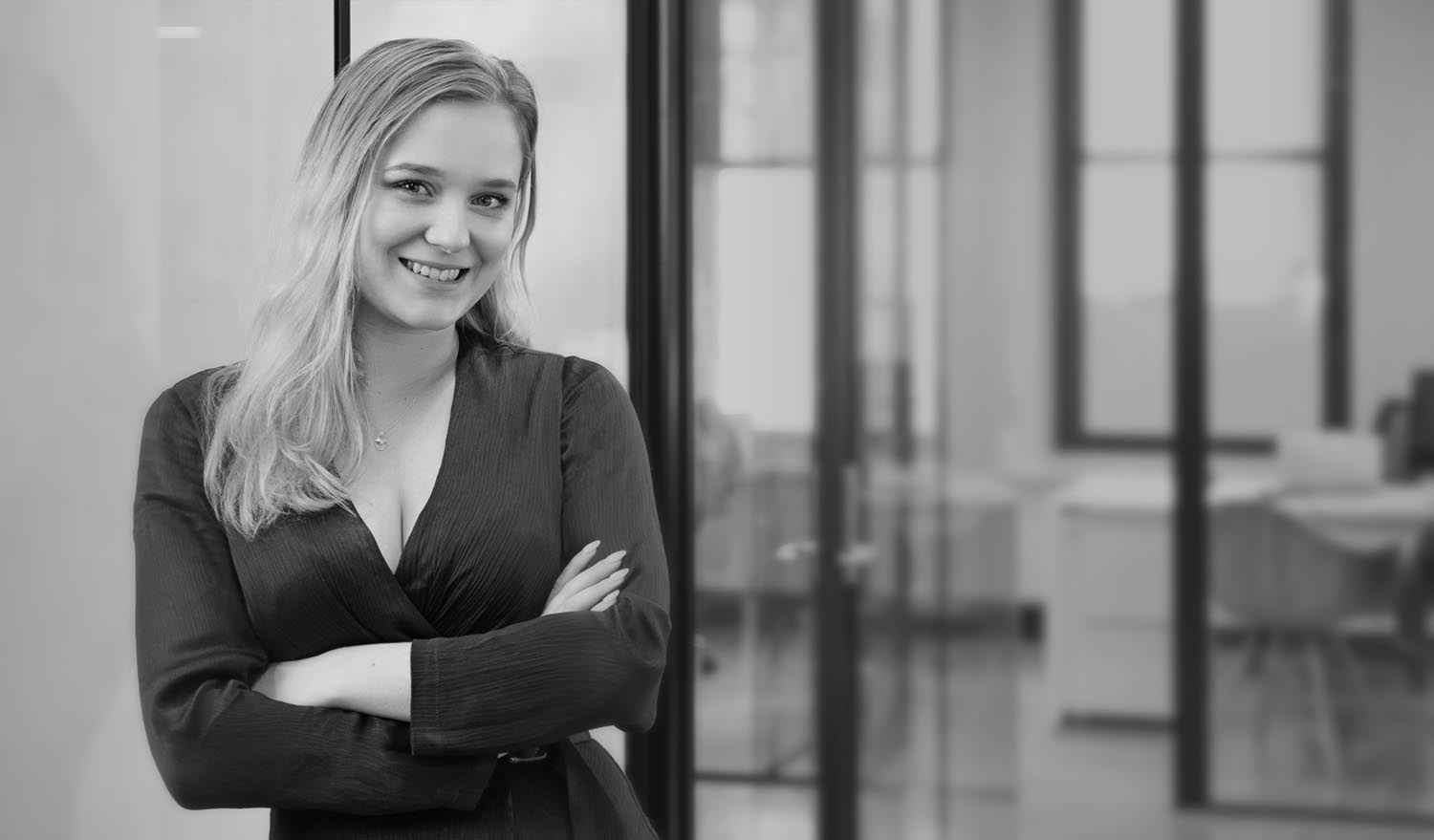 Businesswoman standing in front of office looking confident