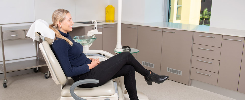 Dental patient sitting in dental chair in Sydney clinic